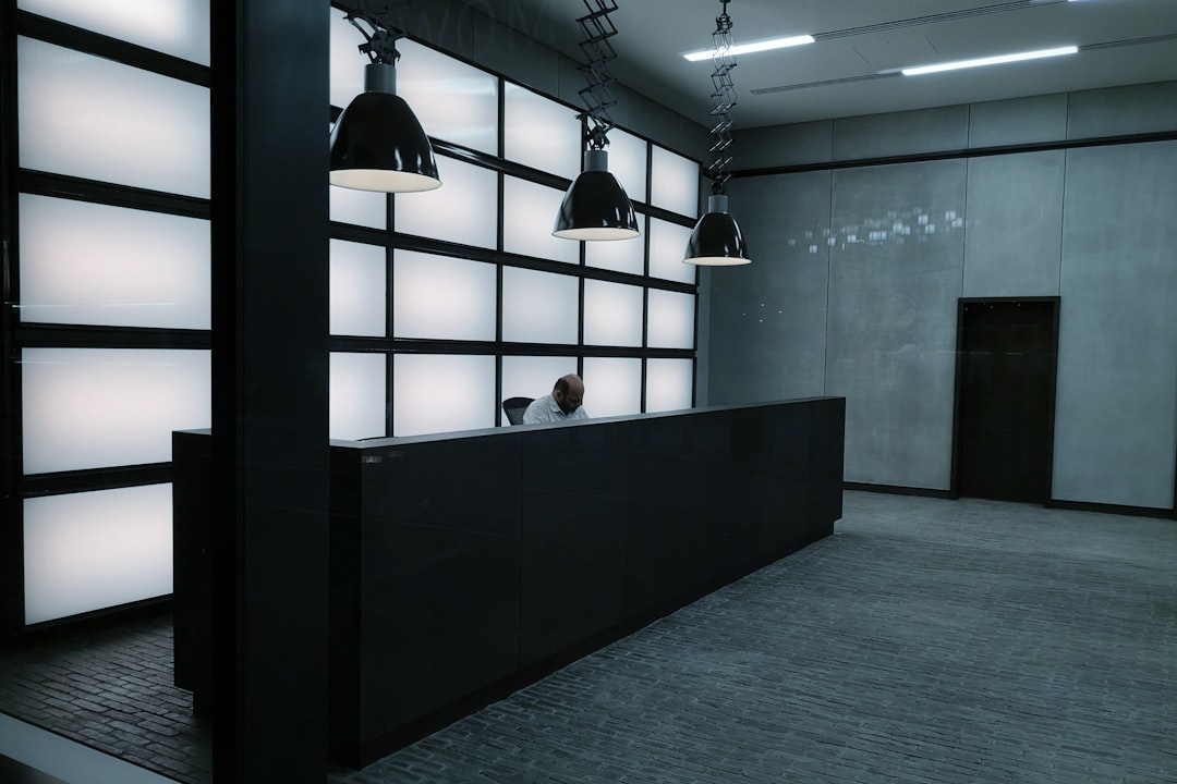 Black pendant lamp turned on in room