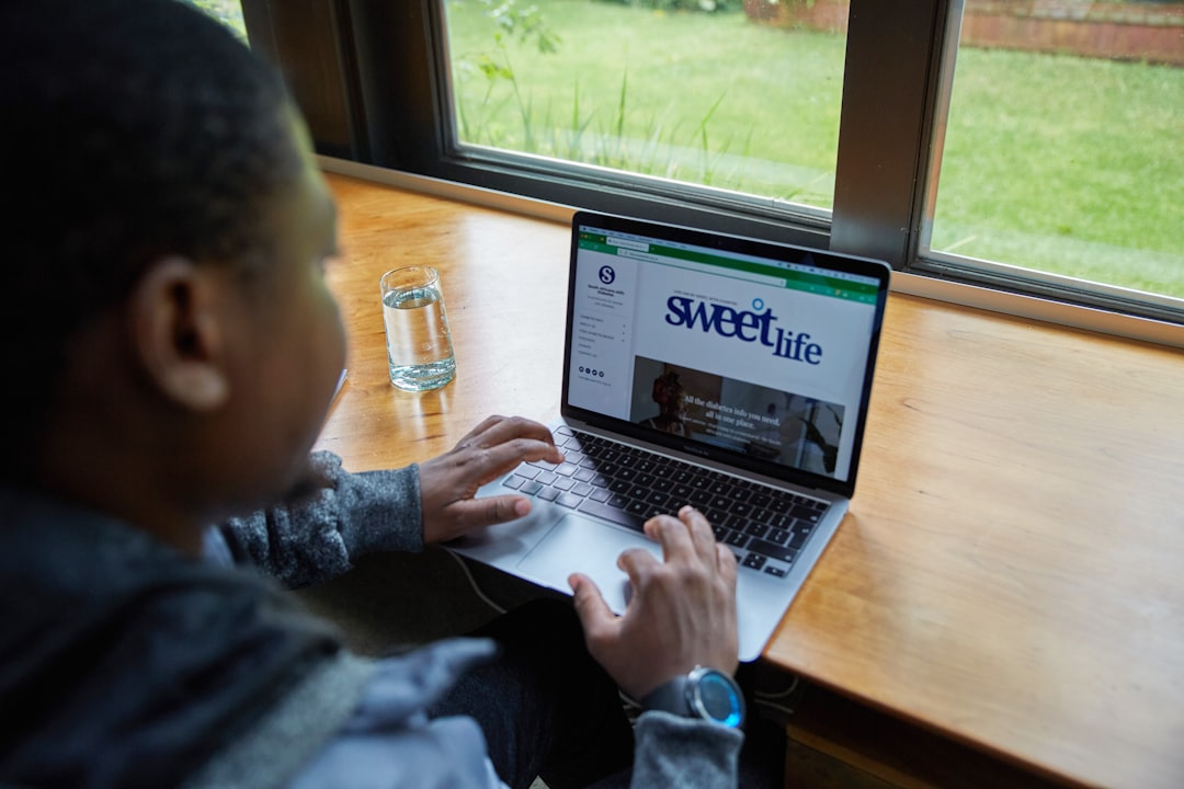 A man sitting in front of a laptop computer