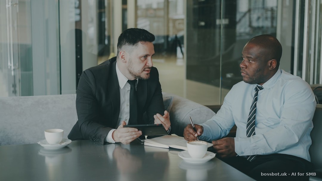 Two businessmen discussing work over coffee.