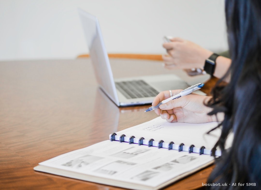 Person holding pen writing on paper