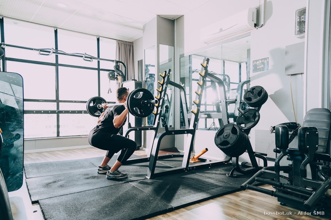 Woman in black shirt and blue denim jeans sitting on black exercise equipment