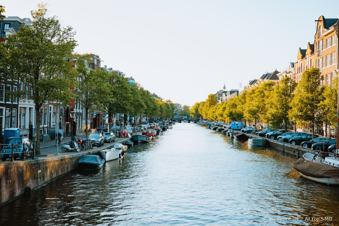 Canal in amsterdam with buildings and boats.