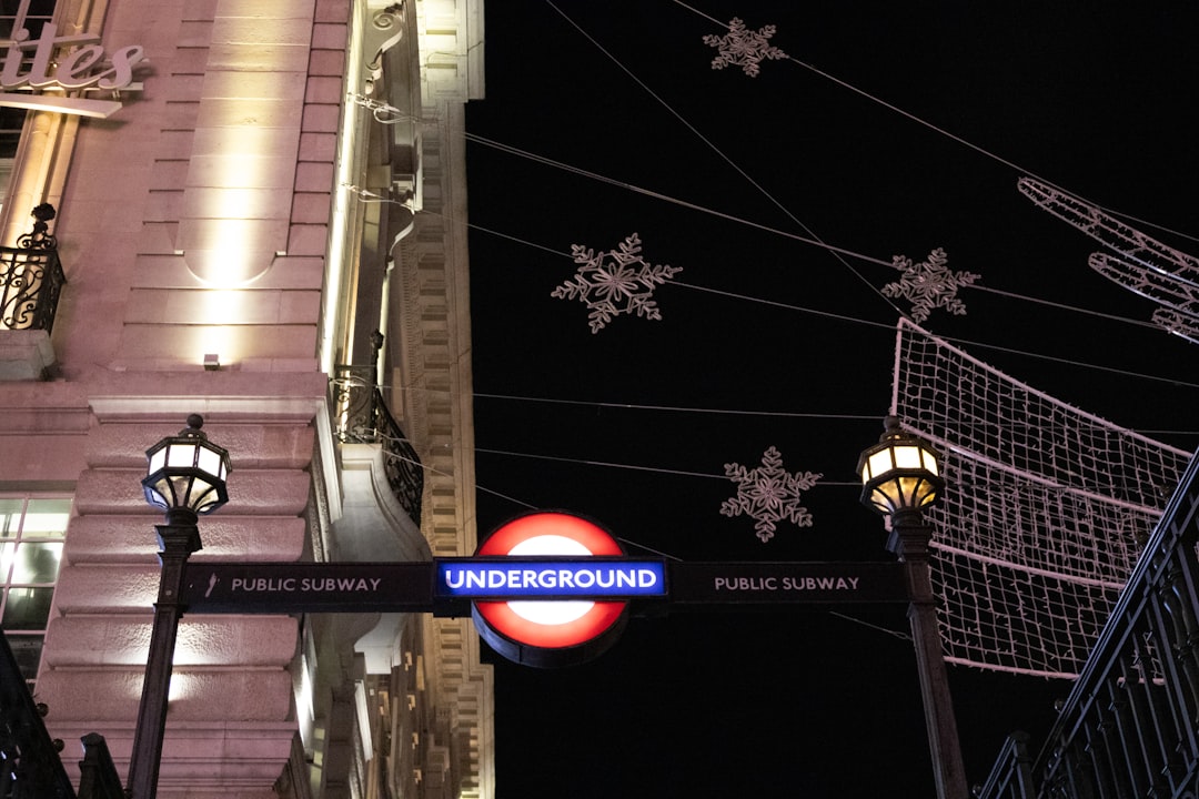 London underground sign with festive lights at night