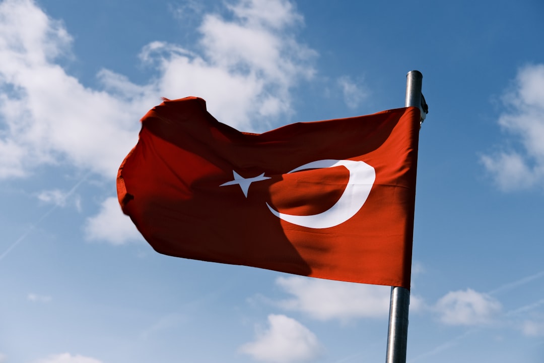 A red flag with a white star and a crescent on it