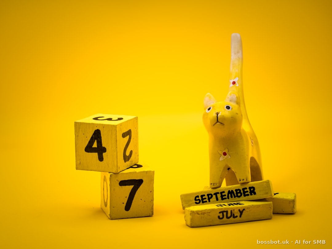 Yellow cat figurine and calendar blocks on yellow background.