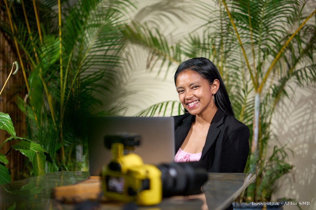 Smiling woman working on a laptop surrounded by plants
