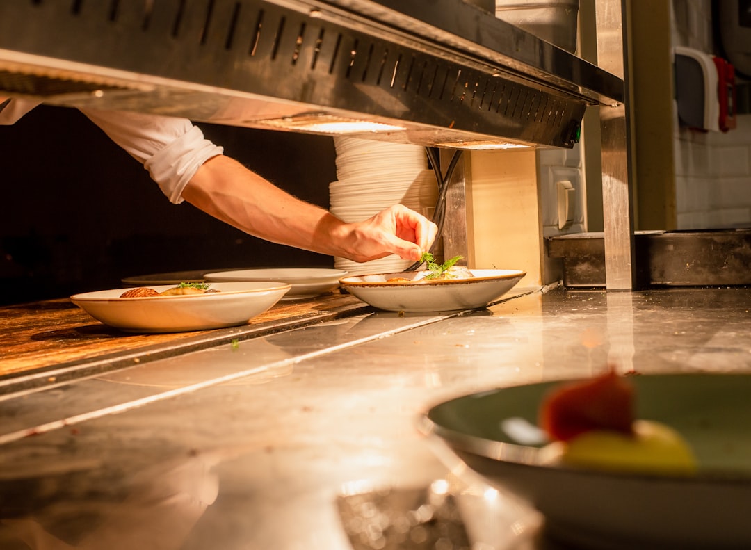Person putting mint on top of dish