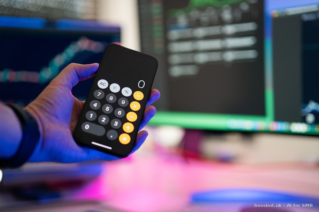A person holding a remote control in front of a computer