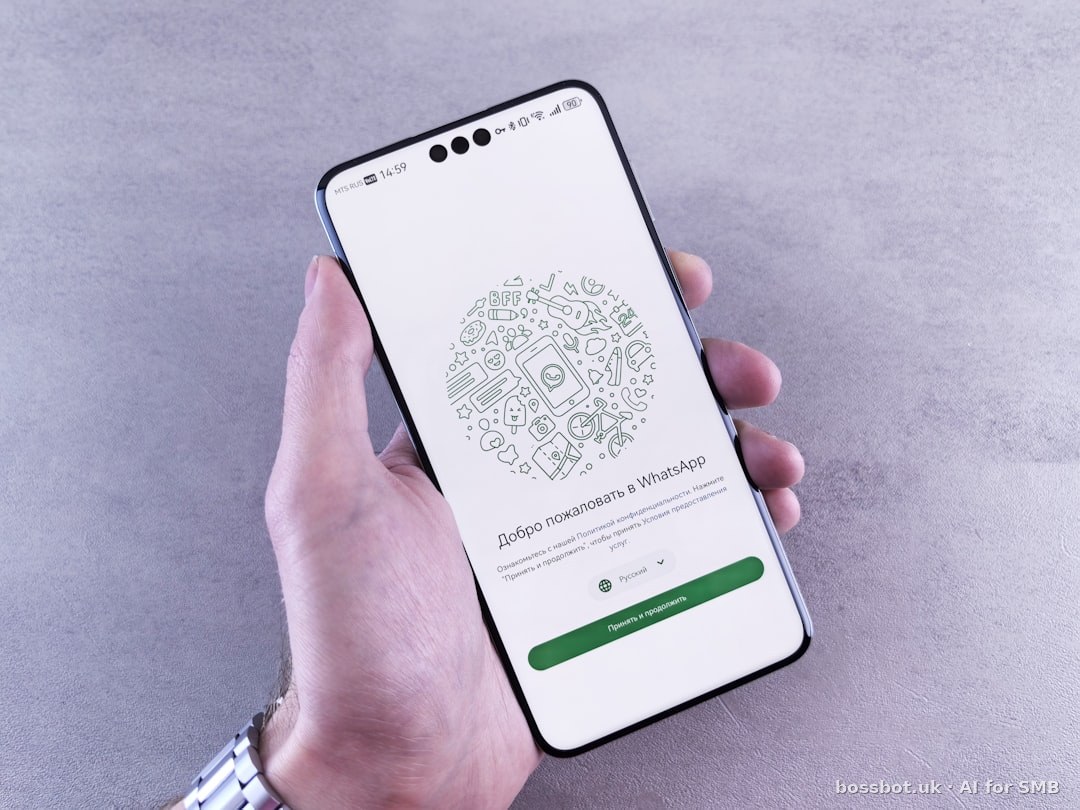 A hand holds a phone with a whatsapp screen.