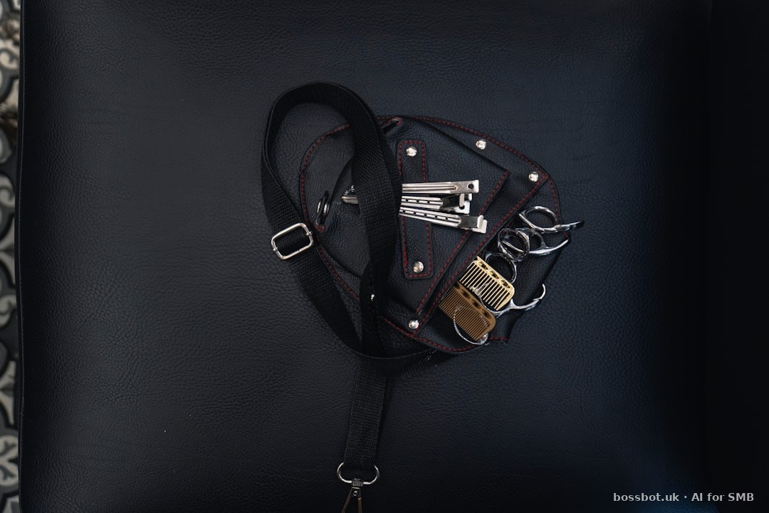 A black purse with a black strap and a gold lock