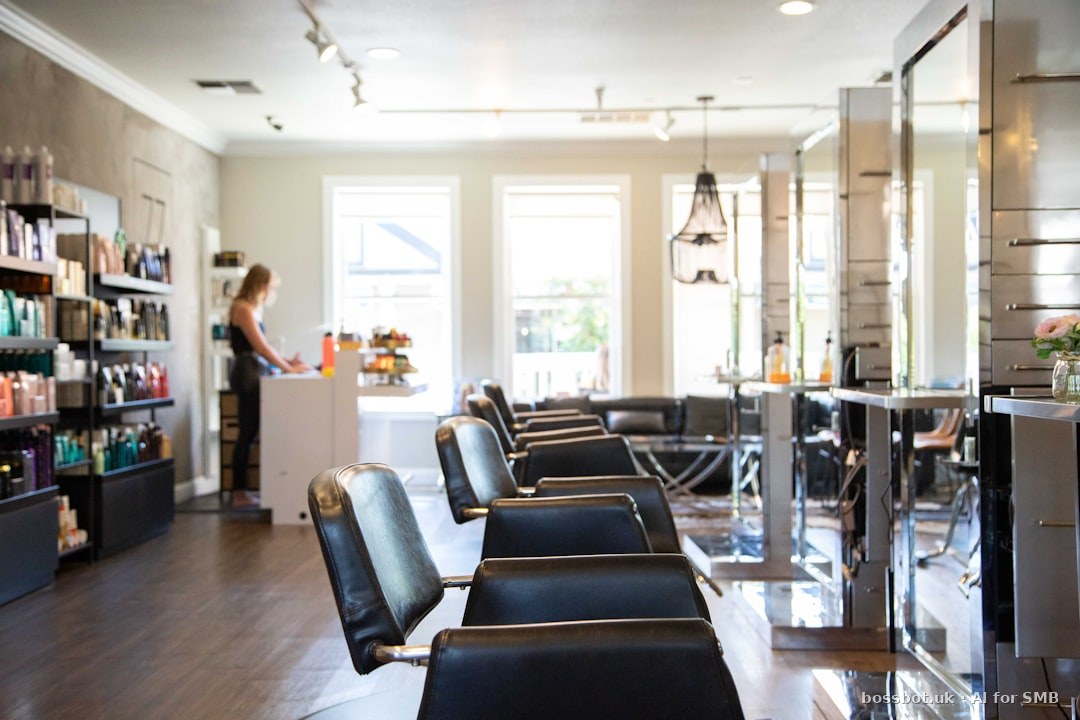 Woman in white shirt standing near black leather chairs