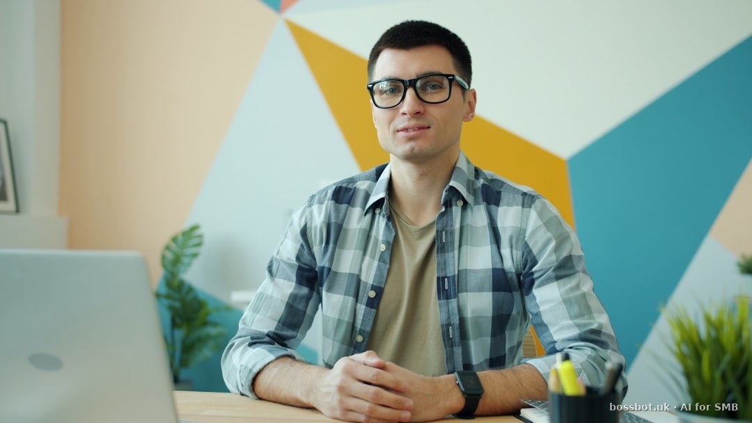 Man wearing glasses sitting at a desk