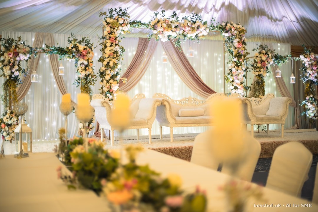 Elegant event stage with floral decor and luxurious seating.
