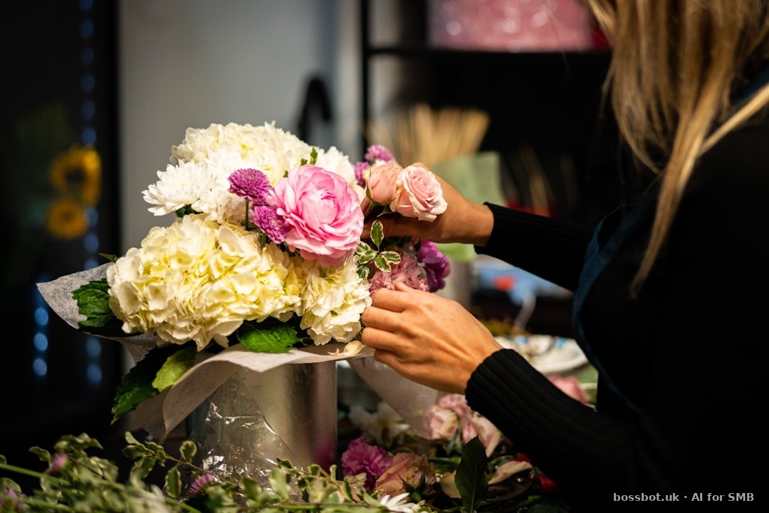 A woman arranging flowers in a vase on a table