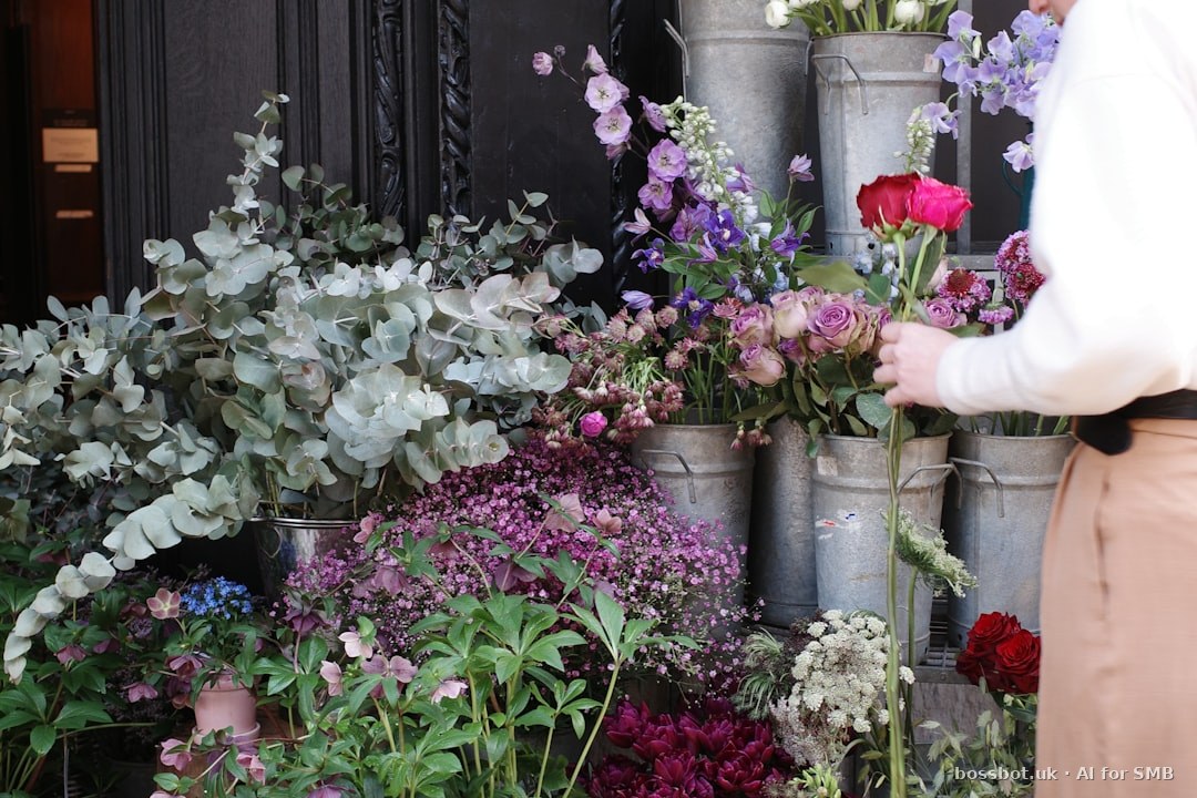 A woman standing next to a bunch of flowers