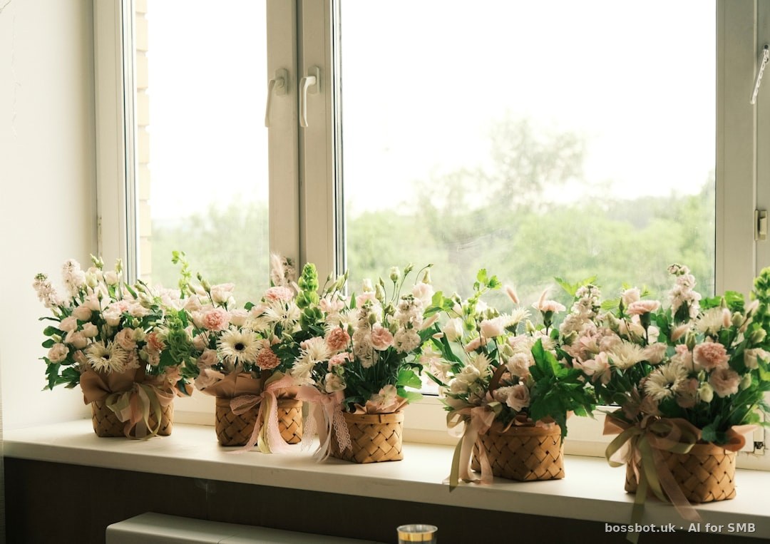 Pink and white flowers in rustic pots on a windowsill.