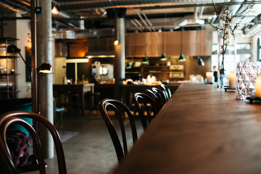 Empty brown wooden restaurant table with chairs