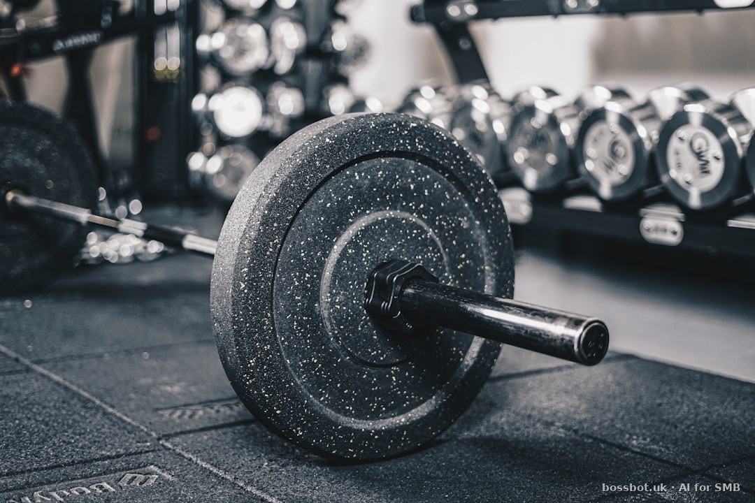 A black and white photo of a barbell in a gym