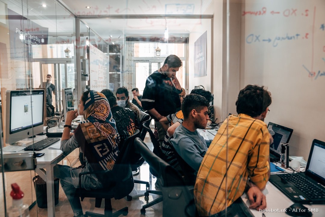 A group of people sitting at computers