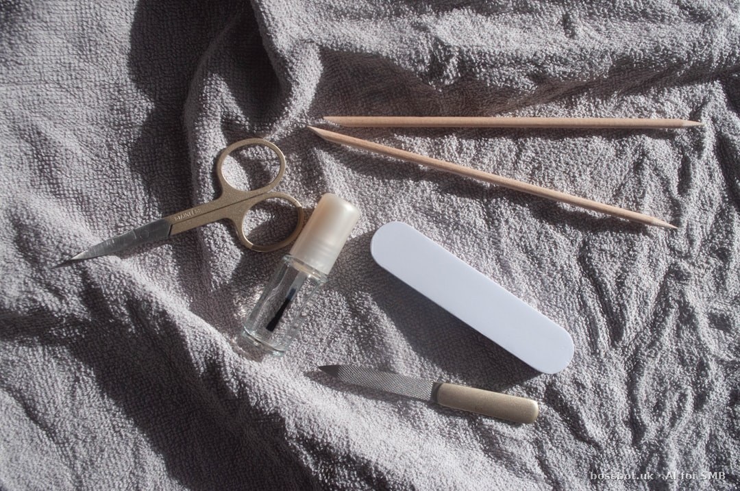 Manicure tools laid out on a white towel.