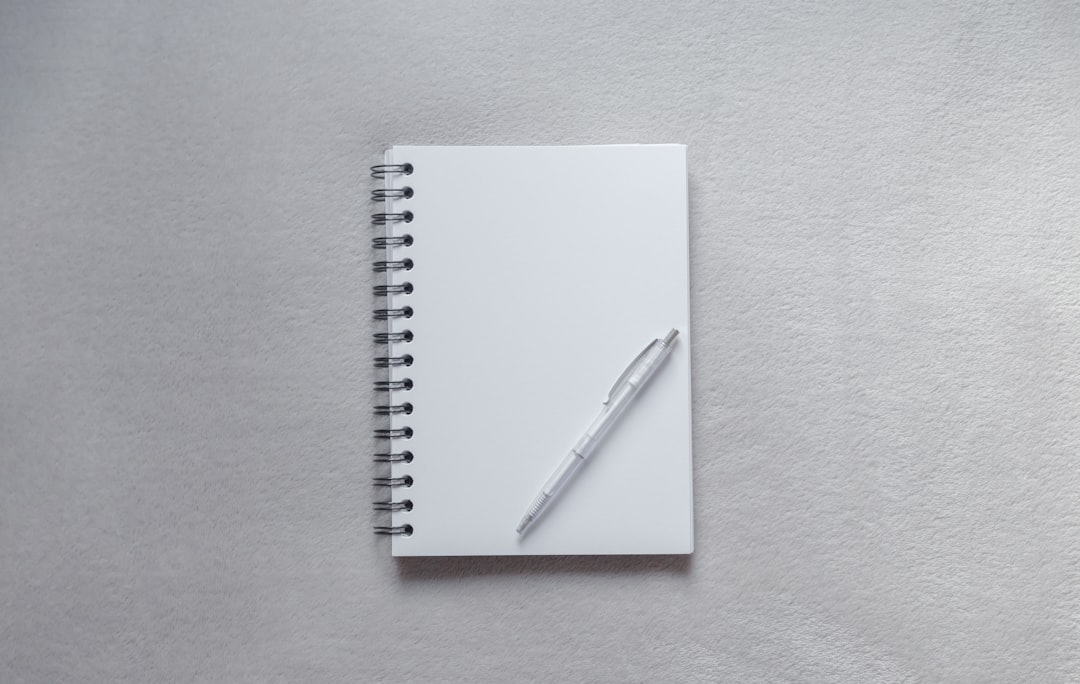 White notebook with pen on top