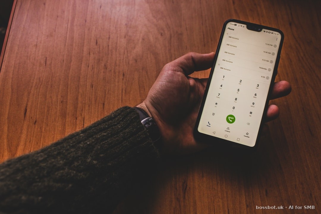 A person holding a cell phone with a green button on it
