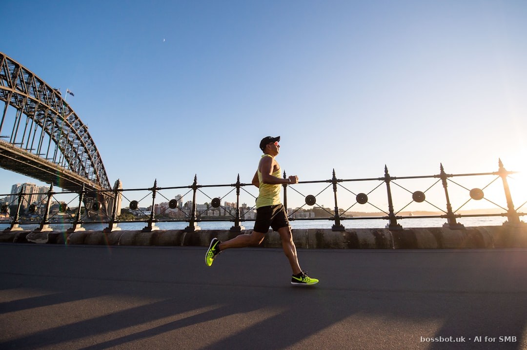 Man in yellow tank top running near shore