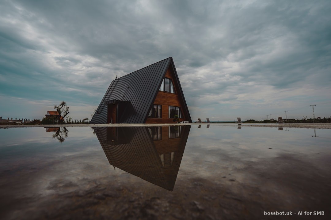 Modern a-frame cabin reflected in still water