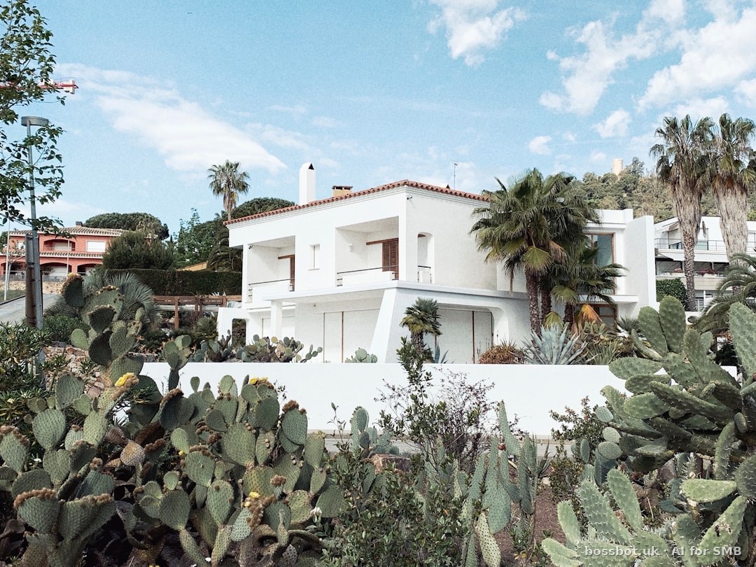 Green trees near white 2-story house