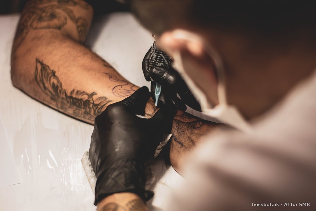 Shallow focus photo of person tattooing person's right arm