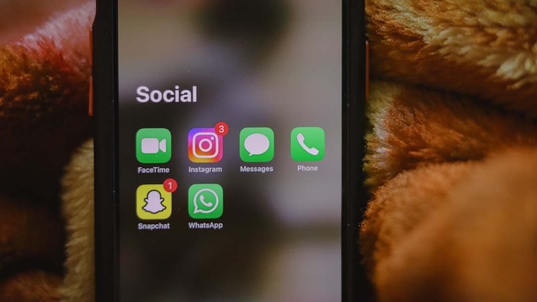 A close up of a cell phone with social icons on it