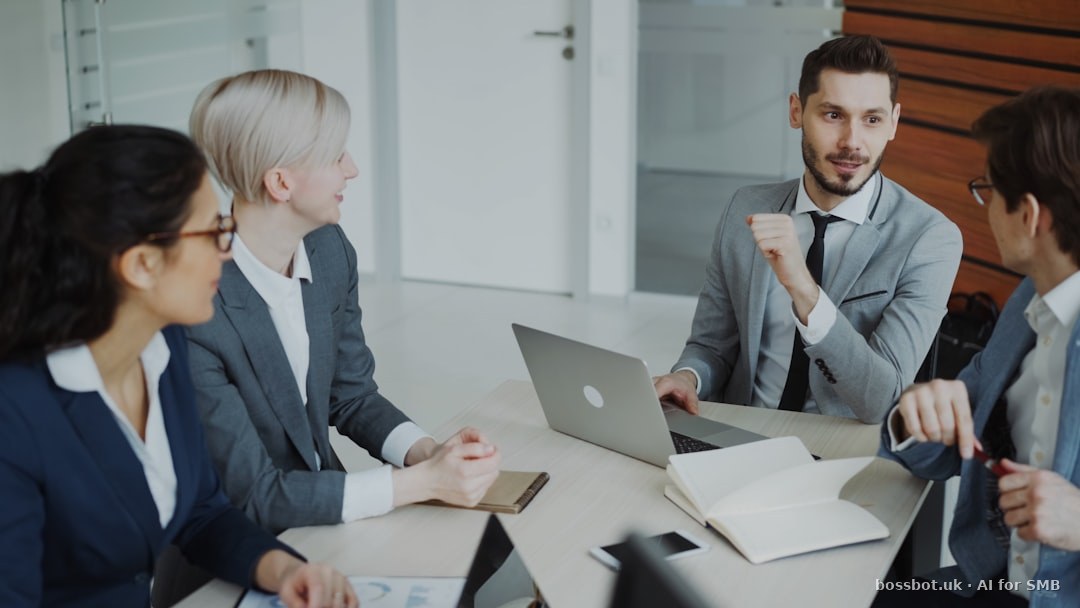 Four professionals in a business meeting around a table